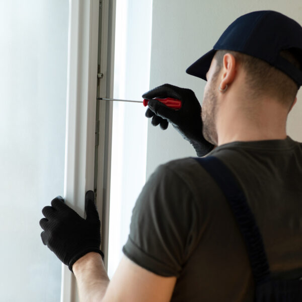 Worker installing new plastic pvc window